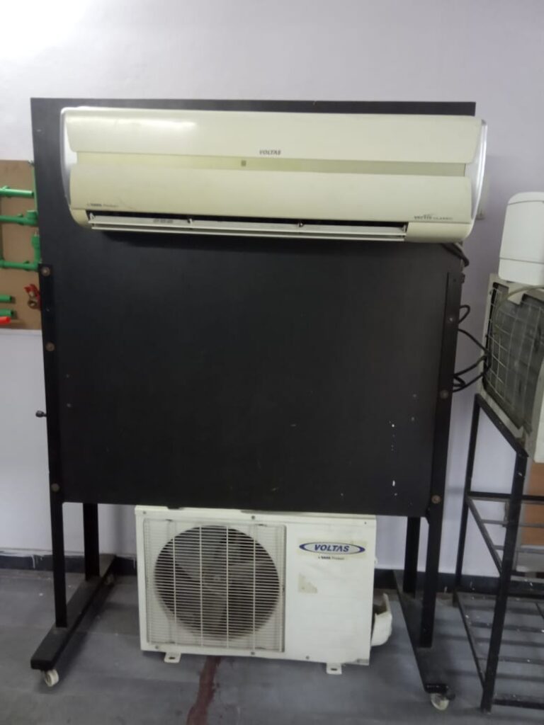 A black and white air conditioner positioned on a table